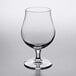 A Reserve by Libbey Belgian beer/tulip glass with a stem on a table.