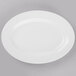 A white Libbey Porcelana oval platter with a wide rim on a gray surface.