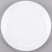 A Libbey Porcelana white round porcelain coupe plate on a gray surface.