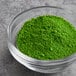 A bowl of green Chefmaster dry powder on a table.