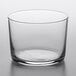 A Libbey Cidra clear glass cup on a white surface.