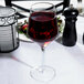 A Reserve by Libbey Prism wine glass filled with red wine on a table.
