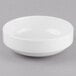 A Libbey Porcelana bright white porcelain bowl on a gray surface.