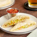 Unbaked Caribbean Food Delights Vegetable Patties on a plate with salsa and a glass of beer.