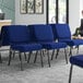 A room with Lancaster Table & Seating silver vein church chairs with navy fabric.