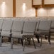 A row of Lancaster Table & Seating church chairs with gray seats.