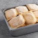 A metal pan filled with unbaked Caribbean Food Delights Spicy Beef Patties.