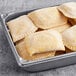 A metal pan of unbaked Caribbean Food Delights Jackfruit Curry Patties.