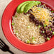A plate of parboiled white rice, beans, avocado, and cheese with a fork.