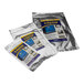 A group of silver bags with blue and yellow labels containing J & J Permanent UV-Cured Repair J-Patches.