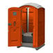 An orange J & J Echo One portable restroom.