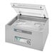 A silver Henkelman BOXER62 vacuum packaging machine on a counter with a lid.