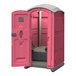 A pink J & J portable restroom structure with a door open.