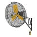 A close-up of a Big Ass Fans wall-mounted fan with yellow and black blades.