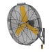 A large black wall-mounted fan with a yellow blade and yellow logo.