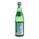 A close up of a San Pellegrino 500 mL glass bottle of sparkling natural mineral water with a label on it.