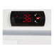 The black digital thermostat with red numbers on a Galaxy GRI-18-RW reach-in refrigerator.