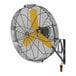 A black wall-mounted fan with yellow blades and a yellow logo.