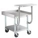 A Regency stainless steel equipment stand with a galvanized undershelf on wheels.