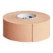 A roll of tan 3M Nexcare waterproof first aid tape.