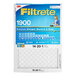 A box of 3M Filtrete air filters with yellow and blue text on a white surface.