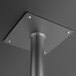 A black metal bar height pin leg with a hole in the center and a square plate on top.