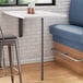A black bar height pin leg on a table in a food truck interior.