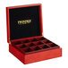 A red Twinings wooden tea box with 12 compartments and a black cover.