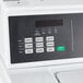 A close up of the control panel on a white Speed Queen commercial washer.