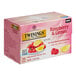 A pink box of Twinings Raspberry & Lemon Herbal Tea Bags with text on it.