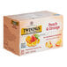 A box of Twinings Peach & Orange Herbal Tea with images of peaches and oranges.