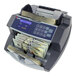 A Cassida 6600 money counting machine counting cash.