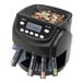 A black Kolibri coin counting machine with coins in it.