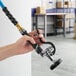 A hand holding a Regency spray nozzle attached to a hose.
