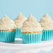 A group of cupcakes with blue frosting and Adourne Pastel Rainbow Sanding Sugar on top.