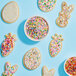 A cookie with white frosting and colorful Adourne Fine Pastel Rainbow Sanding Sugar sprinkles.