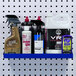 A blue Triton Products steel shelf holding various cleaning products.