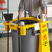 A man standing in front of a yellow Lavex rim caddy on a counter.