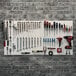 Triton Products white pegboard with tools on it including a drill and screwdriver.