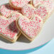 A plate of heart shaped cookies with white and red Adourne Valentine Sanding Sugar sprinkles.