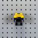 A yellow and black toy truck on a grey peg board with a Triton Products LocHook double rod.