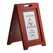 A Lavex wood A-frame wet floor sign with stainless steel plates on a table.