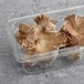 A plastic container of fresh oyster mushrooms.