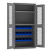 A gray metal Durham storage cabinet with blue bins.