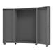 A grey metal Durham storage cabinet with louvered doors on wheels.