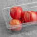 A plastic container with a group of red Royal Gala apples.