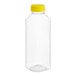 A clear plastic square juice bottle with a yellow lid.