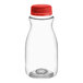 A close-up of a clear PET juice bottle with a red cap.