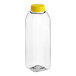 A clear plastic 16 oz. Tall Square rPET juice bottle with a yellow cap.