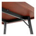 A Lancaster Table & Seating bar height table with metal legs and a mahogany finish.